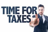 Business man pointing the text Time for Taxes